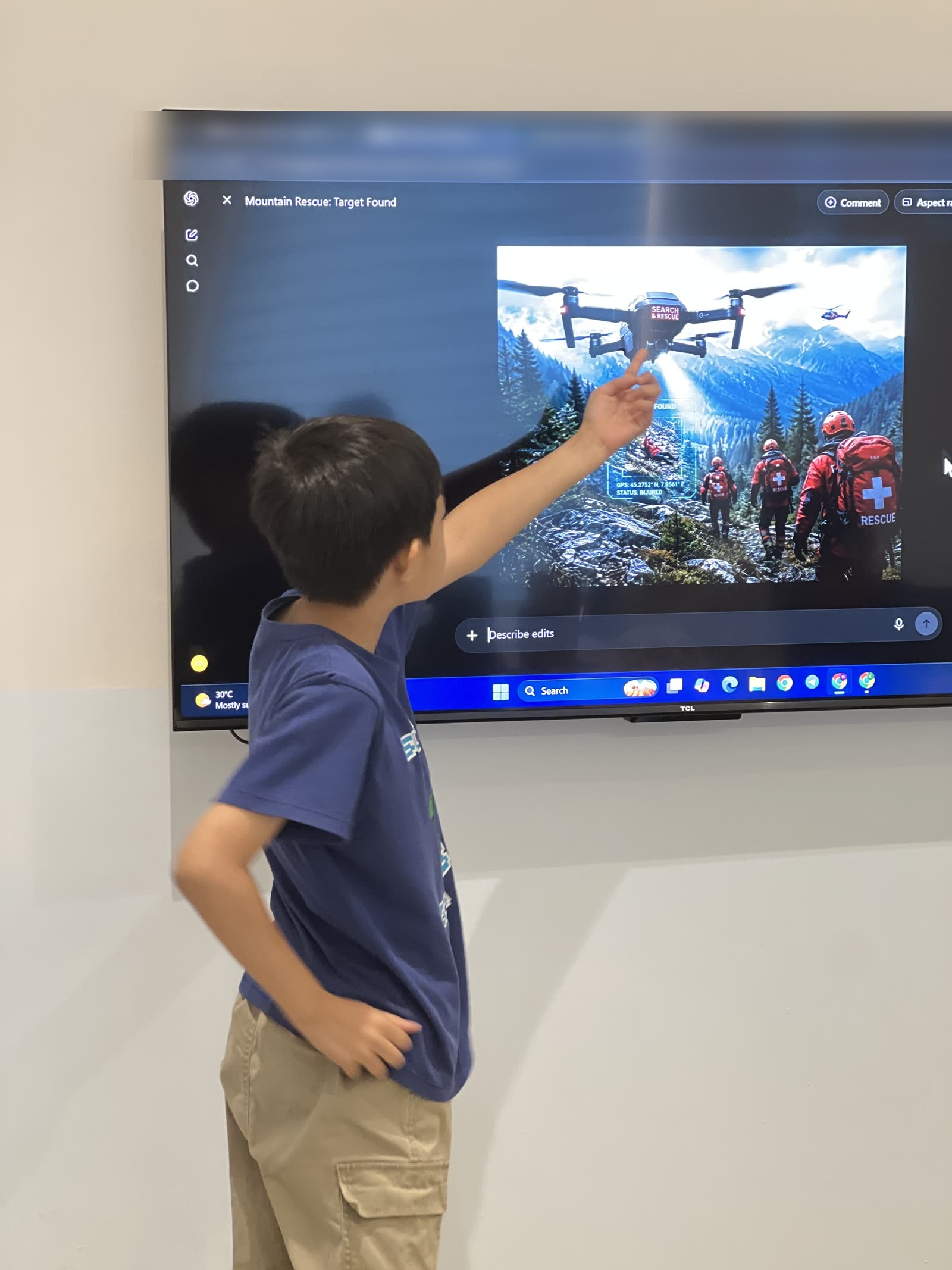Anas standing beside a screen showing his rescue drone over a mountain search scene