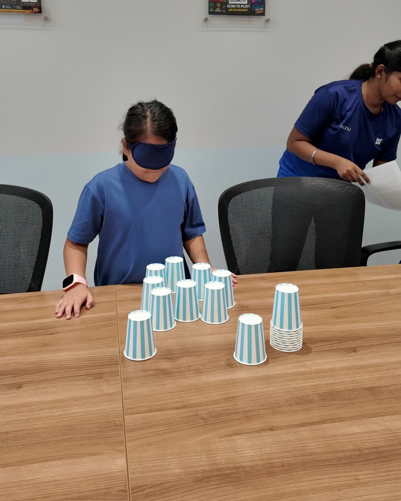 A blindfolded cup-stacking challenge to warm up.